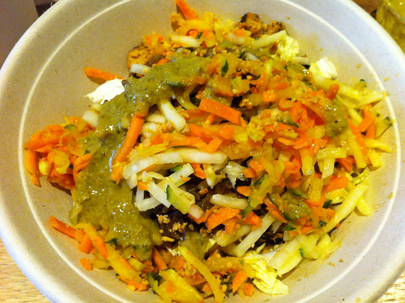 Salad bowl with chicken, eggplant, green papaya slaw, pickles, crushed peanuts, and green curry.