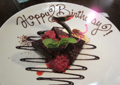 Chocolate Chambord Truffle Cake with raspberry compote and whipped cream.