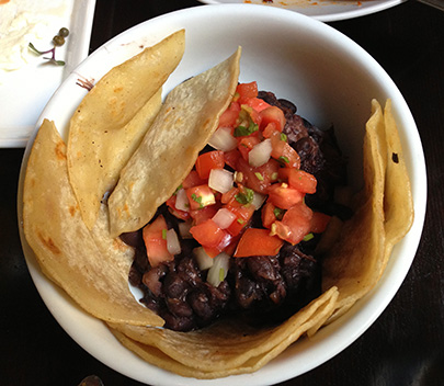 Roasted pork belly and black bean tostada